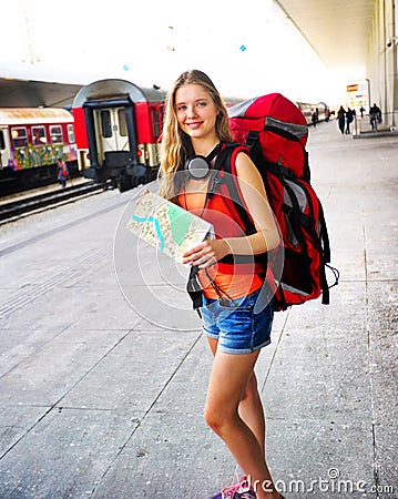 Traveller girl female backpack and tourism outfit at railway station Stock Photo