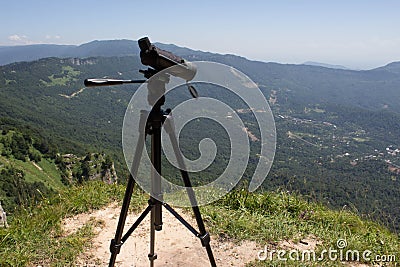 Traveller looking the nature from the high mountain with spotting scope, binoculars tripod Stock Photo