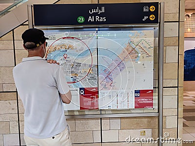 Traveller looking at route map at metro station dubai Editorial Stock Photo