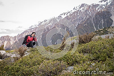 A traveller, photographer man taking photo on the mountain, snow Editorial Stock Photo