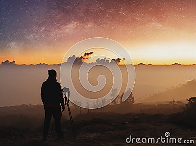 Traveller taking photograph of landscape sunrise and sky full of stars in dawn Stock Photo