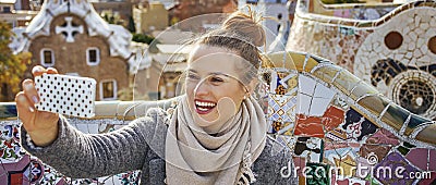 Traveller woman at Guell Park taking selfie with mobile phone Stock Photo