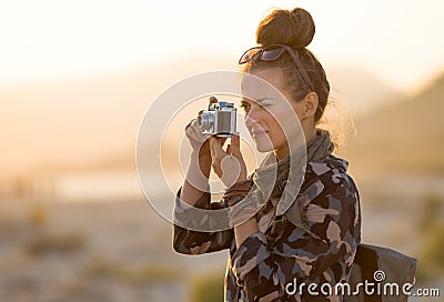 Traveller woman taking photos with retro photo camera Stock Photo