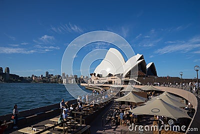 Travellers and local people have drink and enjoy sunny day at Opera bar in front of The Opera Hous Editorial Stock Photo