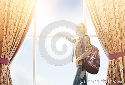 Travelling And Accomodation Concept. Girl Standing Near Big Window Stock Photo