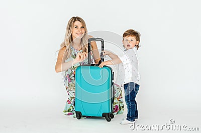 Travelling with kids. Happy mother with her child packing clothes for their holiday. Summer, vacation Stock Photo
