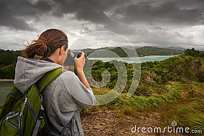 Travelling woman photographer with backpack Stock Photo