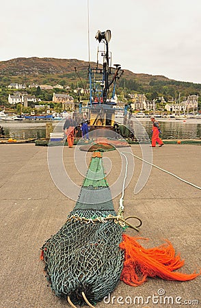 Trawl net repairs, Tarbert, Scotland Editorial Stock Photo