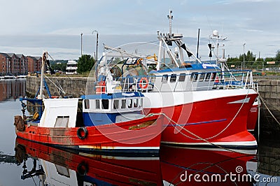 Trawler fishing red boat at Peterhead harbour in Scotland Stock Photo