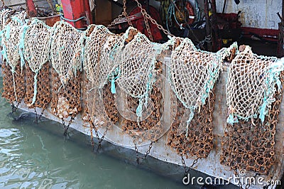 Trawlers or fishing vessels with nets for escallop St James shell fishing in harbour of a fishing port in Port-en-Bessin-Huppain Stock Photo