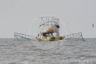 Trawling boat catching shrimp in Vermillion bay in louisiana. Stock Photo