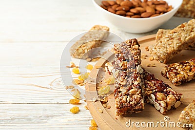 Tray with granola bars and bowl with almond on white wooden background Stock Photo