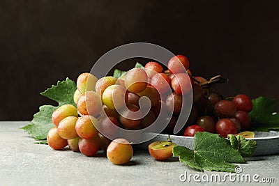 Tray grape on gray table against brown background Stock Photo