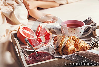 Tray with light breakfast in bed Stock Photo
