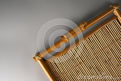 A tray made entirely of bamboo on a gray background. Stock Photo