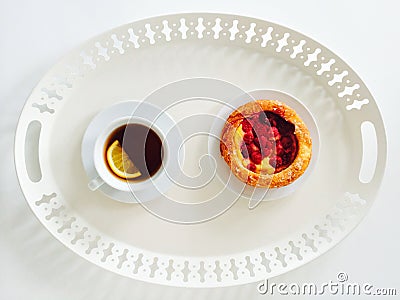 Tray with raspberry pastry and cup of tea Stock Photo