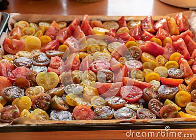 Tray with sliced tomatoes, different colors and shapes, autumn harvest Stock Photo