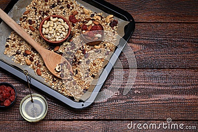Tray with tasty granola, nuts and dry fruits on wooden table, flat lay. Space for text Stock Photo