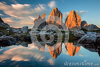 Tre Cime di Lavaredo with reflection in lake at sundown, Dolomites Alps Stock Photo