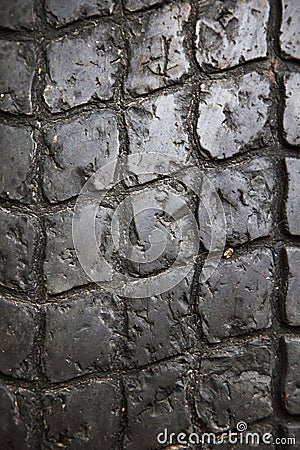 Tread of an old worn black rubber tire Stock Photo