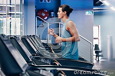 Treadmill, running and profile of man in gym for cardio workout and heart health. Fitness, sports and male runner on Stock Photo