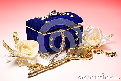 Treasure. Golden key, wedding rings and white roses Stock Photo