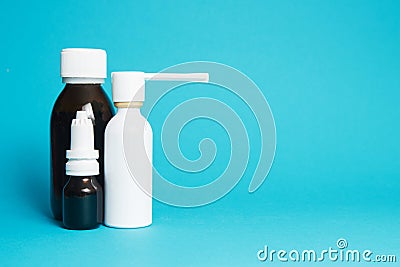 Treatment of colds and flu. Various medicines, sprays from a stuffy nose and a pain in a throat on a blue background. Copy space Stock Photo