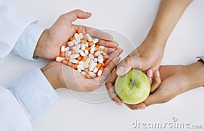 Treatment is a combination of many forms. Closeup shot of a medical practitioner holding a variety of pills while her Stock Photo