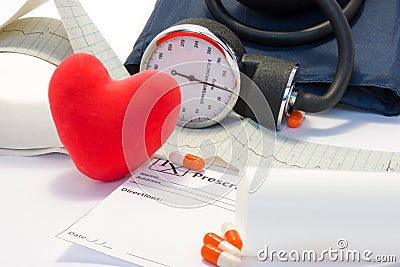 Treatment of heart, hypertension and cardiovascular disease concept photo. Volume model card red heart lies on table near the EKG Stock Photo