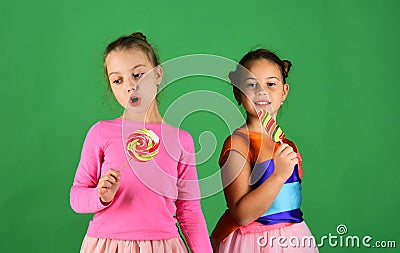 Treatment and sweets concept. Children eat big colorful sweet caramels Stock Photo