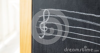 Treble clef on a chalkboard drawn by a child, chalk drawing, object detail, closeup, front view, nobody. Music, violin clef Stock Photo