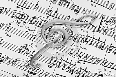 Treble clef on music sheet - musical background Stock Photo