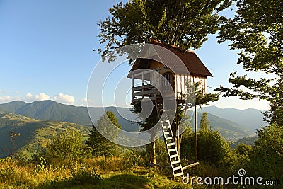 Tree house in the mountains, a children`s treehouse Stock Photo