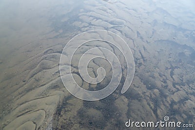 Tree mirrored in the puddle mirror ont he meadow in nature. Stock Photo