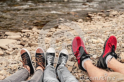 Pairs of legs in black gumshoes Stock Photo