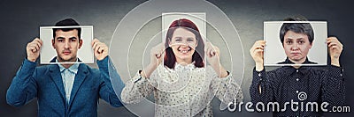 Tree people covering their faces using photo sheets with happy, sad and neutral emotions, like mask to hide real expression from Stock Photo