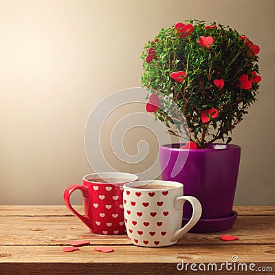 Tree plant with heart shapes and cups of tea for Valentine's day celebration Stock Photo