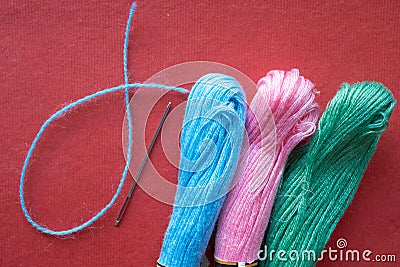 Tree skeins of yarn and one needle Stock Photo