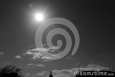 City park, the roof of the monastery, a dome with a cross, and above them - the sun and clouds. Stock Photo