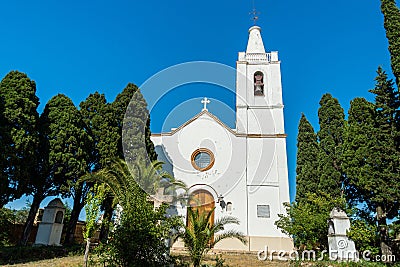 Trees on the sides of Iglesia Santa Maria Magdalena under the blue sky Stock Photo