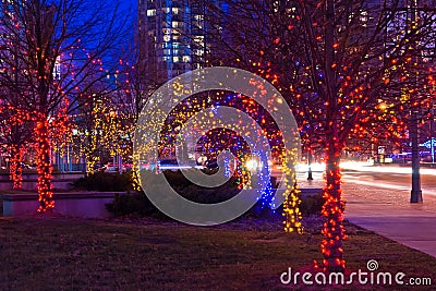 Trees on street decorated with christmas lights Stock Photo