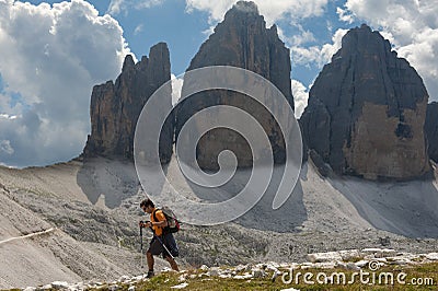 Trekker in front of the Drei Zinnen in a cloudy day of summer, D Editorial Stock Photo