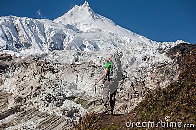 Trekker in front of Manaslu glacier on Manaslu circuit trek in N Stock Photo