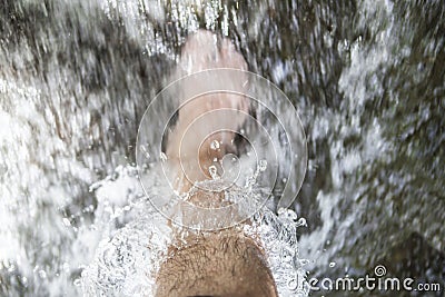Trekker refreshing feet with mountain water from ancient acequia Stock Photo