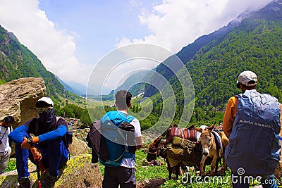 Trekkers with backpacks, looking at the view. Himachal Pradesh Editorial Stock Photo