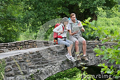 Trekkers relaxing on the stone bridge Stock Photo