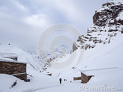 Trekkers walking on the snow mountain pass with the lodges along the way Stock Photo