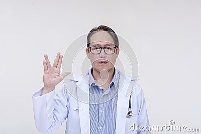 A trekkie fan and doctor makes the vulcan live long and prosper sign. Of asian descent, middle aged male in his 40s. Stock Photo