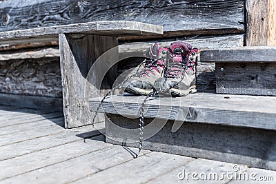 Trekking boots on the veranda of an alpine hut. Summer holidays in the mountains Stock Photo