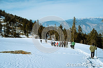 Trekking groupreturnig from Kedarkantha peak Editorial Stock Photo